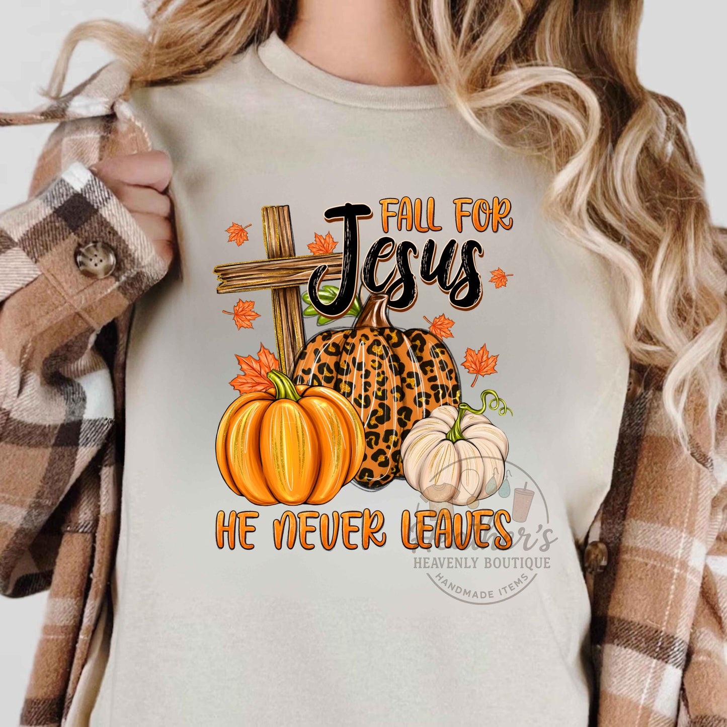 Person wearing a shirt with 'Fall for Jesus' design featuring pumpkins and a cross.