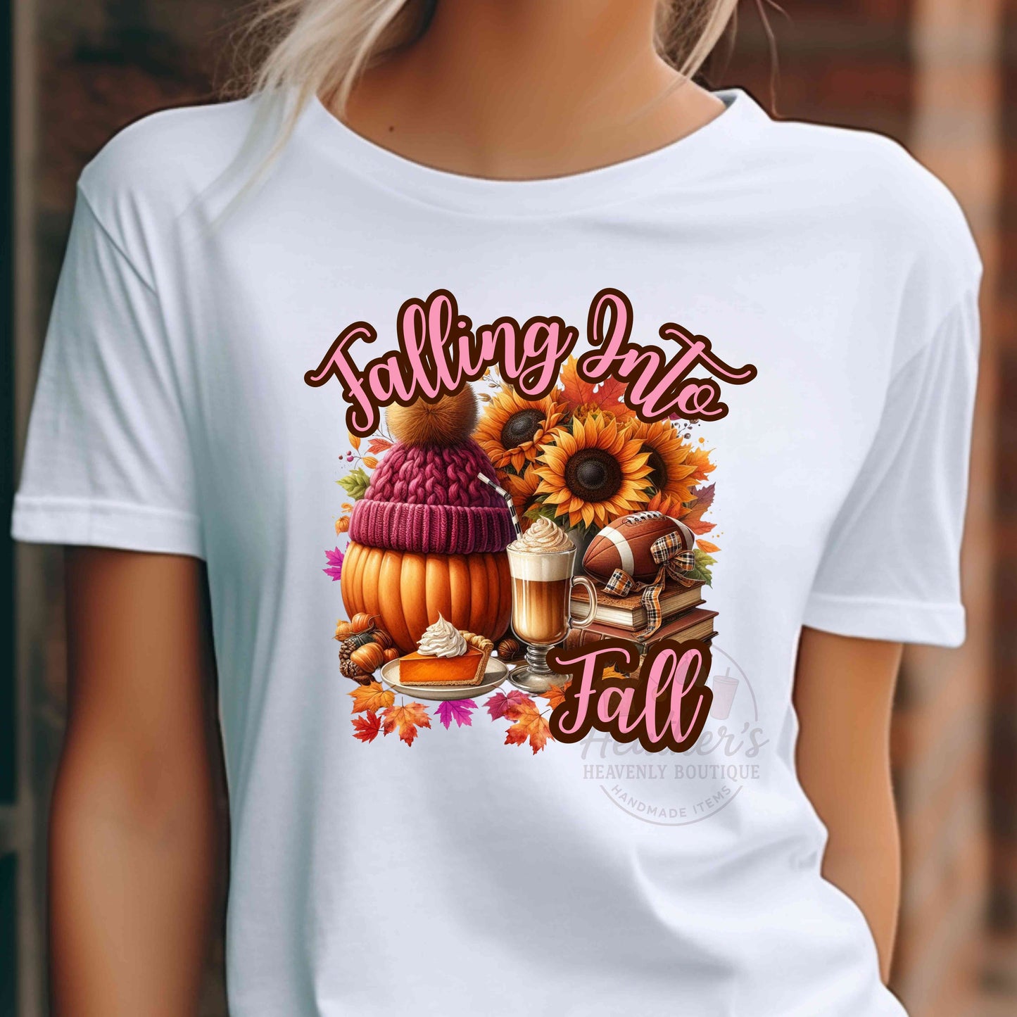 White t-shirt with 'Falling Into Fall' graphic featuring pumpkins, sunflowers, and other fall elements.
