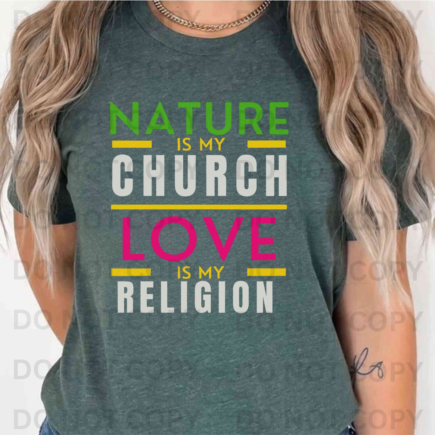 Person wearing a green t-shirt with colorful text design that says, "Nature is my Church Love is my Religion"