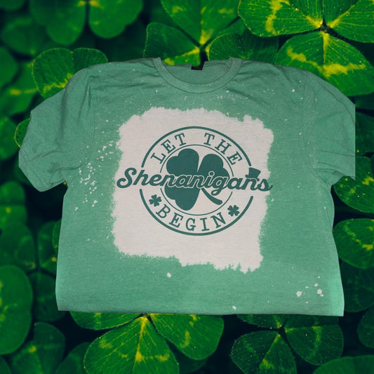 Let The Shenanigans Begin St. Patrick’s Day Clover Bleached Handmade Sublimation T-Shirt  ￼ - Heather's Heavenly Boutique