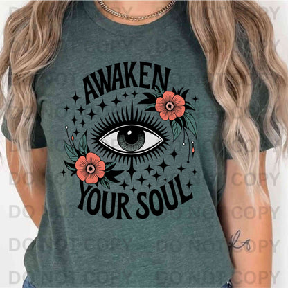 Awaken Your Soul spiritual graphic T-shirt on Gildan cotton, featuring all-seeing eye with floral and star design – unisex spiritual and meditation tee.