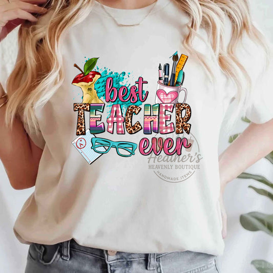 White t-shirt with colorful 'best teacher ever' design and text overlay.