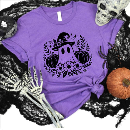 Purple t-shirt with Halloween-themed design featuring a ghost, pumpkins, and flowers on a black lace background.