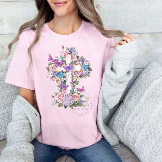 Person wearing a pink t-shirt with floral and butterfly design