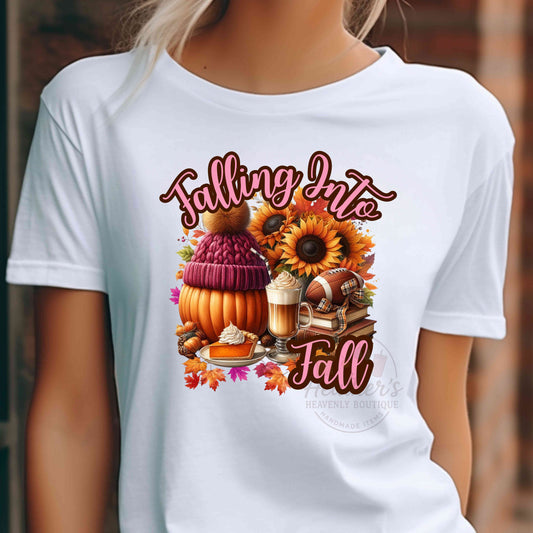 White t-shirt with 'Falling Into Fall' graphic featuring pumpkins, sunflowers, and other fall elements.