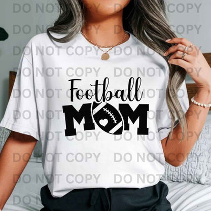 White Gildan cotton Football Mom T-shirt with bold black lettering and heart football design, perfect for game day and sports moms"