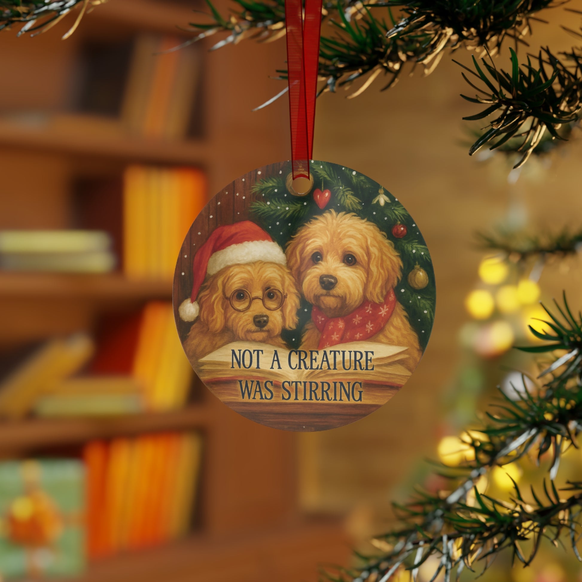 Christmas ornament with two dogs wearing Santa hats on a tree branch.