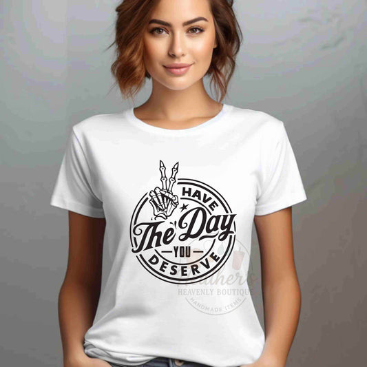 Woman wearing a white t-shirt with a black graphic design on a gray background