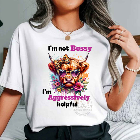 Person wearing a white t-shirt with a colorful graphic of a cow and text.