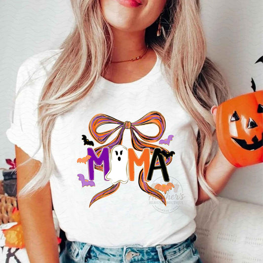 Person wearing a Halloween-themed 'MOM' t-shirt holding a pumpkin.