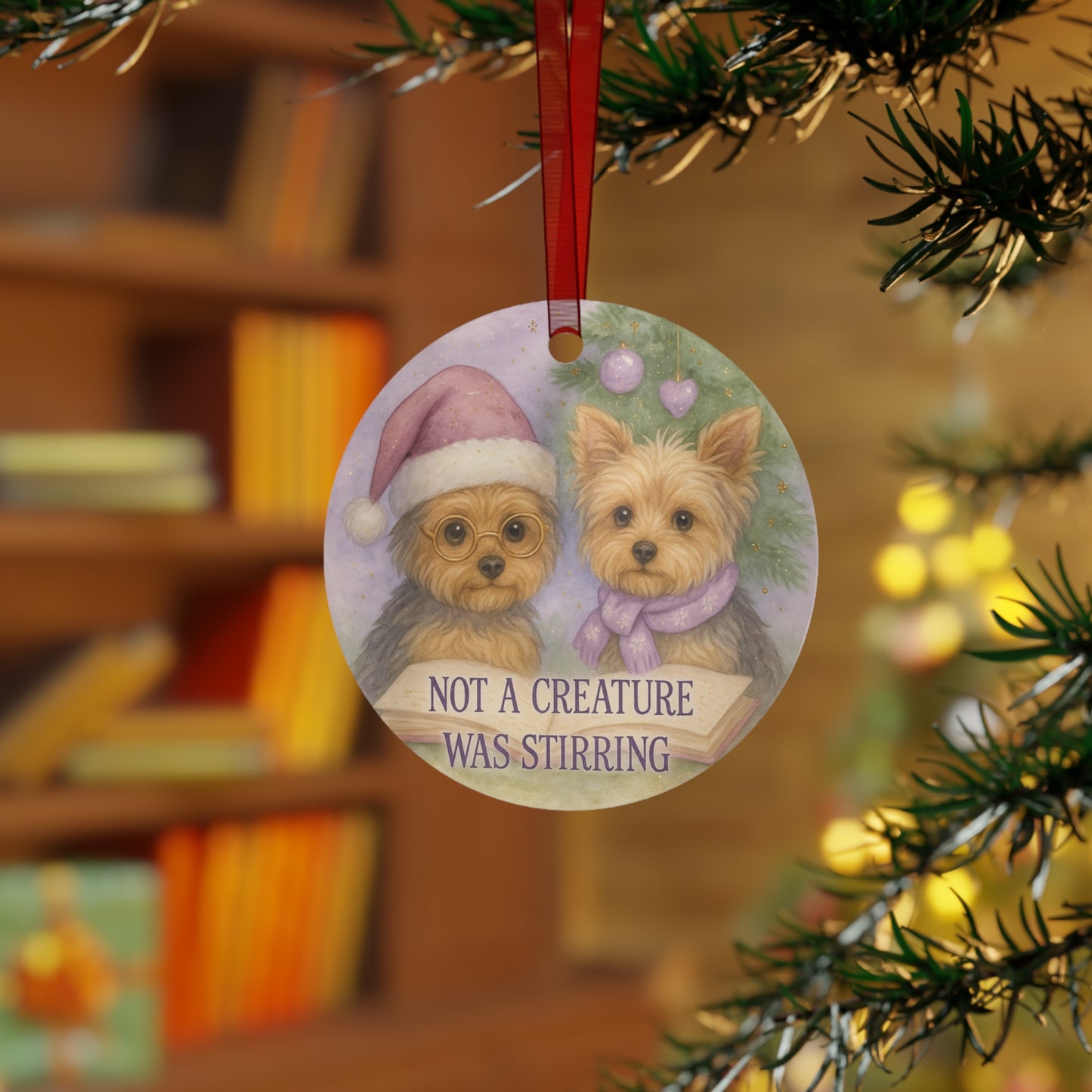 Christmas ornament with two dogs wearing Santa hats and a scarf, hanging on a tree.